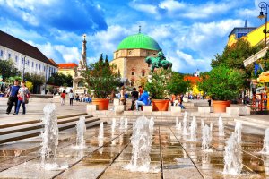 Szechenyi Square in Pecs with monuments and mosque-church museum.Pecs is the fifth largest city of Hungary, it is the administrative centre of Baranya